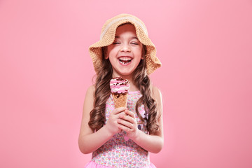 Portrait of a little cheerful girl with ice cream on a colored background