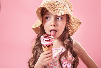 Portrait of a little cheerful girl with ice cream on a colored background