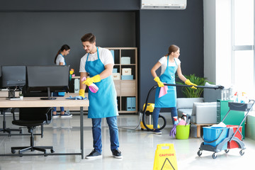 Team of janitors cleaning office
