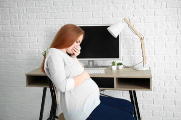 Young pregnant woman suffering from toxicosis at home