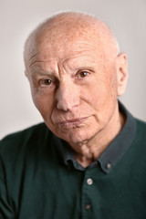 Portrait of senior man on grey background