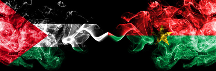 Palestine vs Burkina Faso smoky mystic flags placed side by side. Thick colored silky smokes flag of Palestinians and Burkina Faso