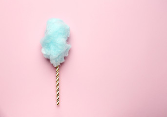 Tasty cotton candy on color background