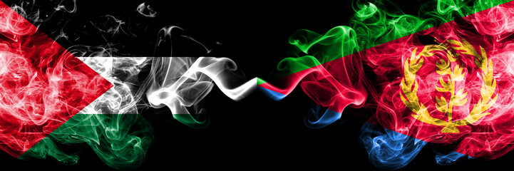 Palestine vs Eritrea smoky mystic flags placed side by side. Thick colored silky smokes flag of Palestinians and Eritrea