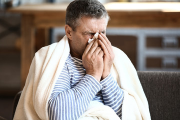 Mature man ill with flu at home