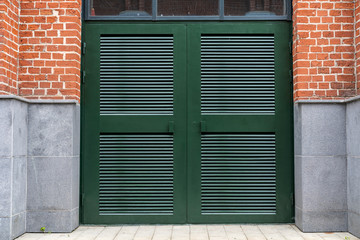 green metal gate with bars