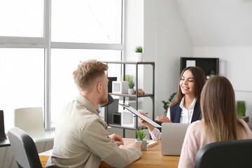Young couple in office of real estate agent