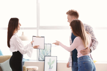 Real estate agent working with young couple