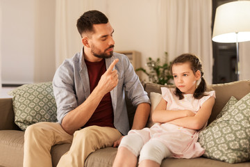 parenting, family and people concept - upset or feeling guilty girl and father at home