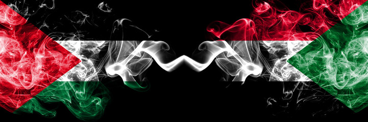 Palestine vs Sudan, Sudanese smoky mystic flags placed side by side. Thick colored silky smokes flag of Palestinians and Sudan, Sudanese