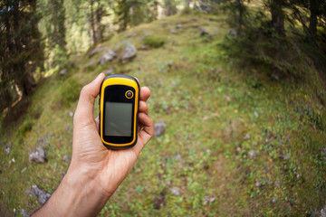 a trekker using a gps inside the forest