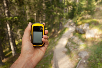 a trekker using a gps inside the forest