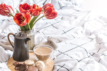 Still life cozy Breakfast with coffee and flowers in the bedroom