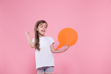 Cute little girl with an icon of a speech on a pink background