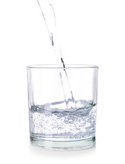Pouring of fresh water into glass on white background