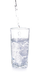 Pouring of fresh water into glass on white background