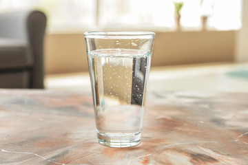 Glass of fresh water on table