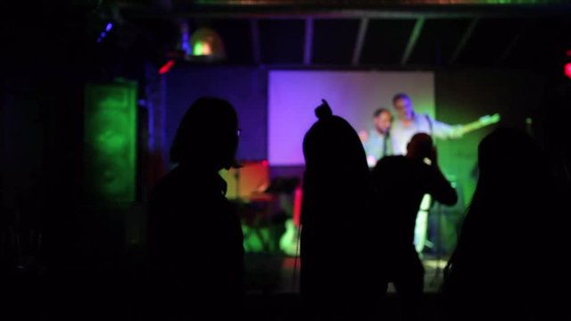 group of fans listening to their favorite group in a small club