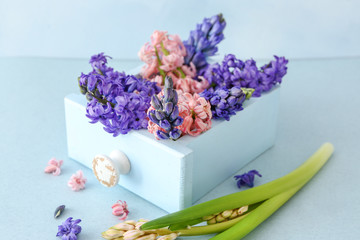 Box with beautiful hyacinth flowers on table