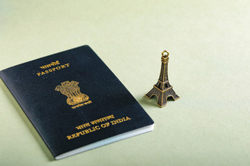 travel concept , Indian passport with Eiffel tower miniature