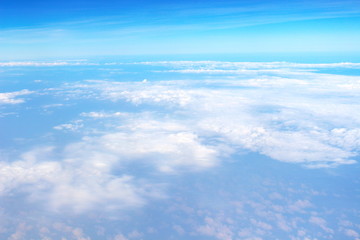 Naklejka na ściany i meble Beautiful of blue sky and white cloud looks from the window of the plane.