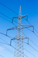 High-voltage electric main against the dark blue sky
