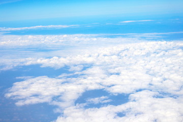 Beautiful of blue sky and white cloud looks from the window of the plane.