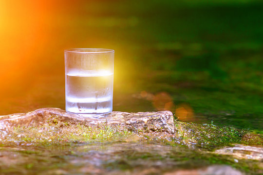 The Glass Of Cool Fresh Water On Nature Background