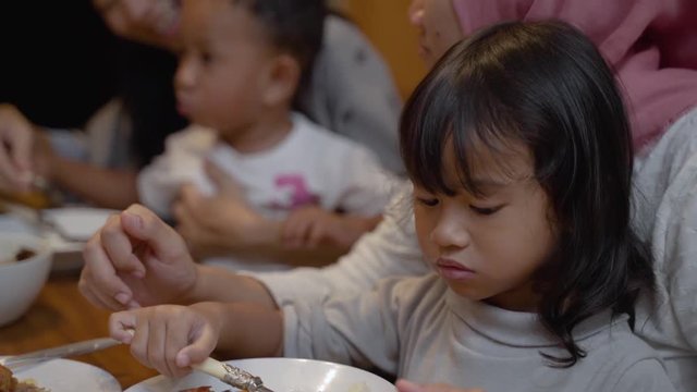 portrait of mother feeding their child on dinner at home