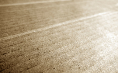 Fototapeta na wymiar Cardboard close-up with blur effect in brown tone.