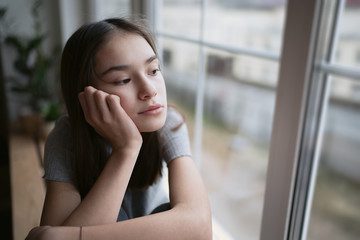 Sad teenager feeling bad alone, feeling depressed, regrets of mistake, having problems, adolescent girl with broken heart           