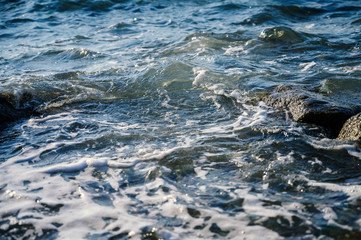 Waves at the seashore. Selective focus with shallow depth of field.