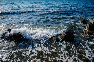 Waves at the seashore. Selective focus with shallow depth of field.