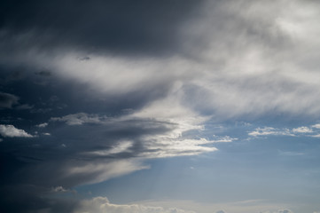 Naklejka na ściany i meble Dark blue sky with clouds. Nature background.
