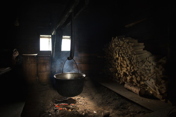 The cheese is cooked in a large cauldron