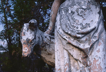 abandoned sculpture of a woman and a deer
