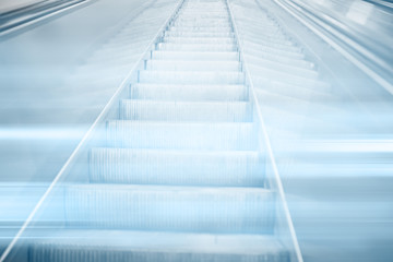 Obraz premium blurred background metro escalator / light blue background movement city infrastructure subway