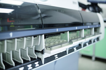 Close-up of automated dissolution sampler with different sections placed in pharmaceutical laboratory