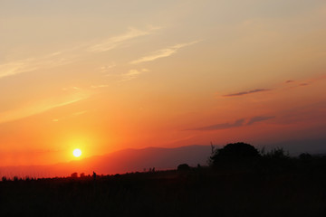 Fototapeta na wymiar Amazing sunset sunrise with sun over mountain