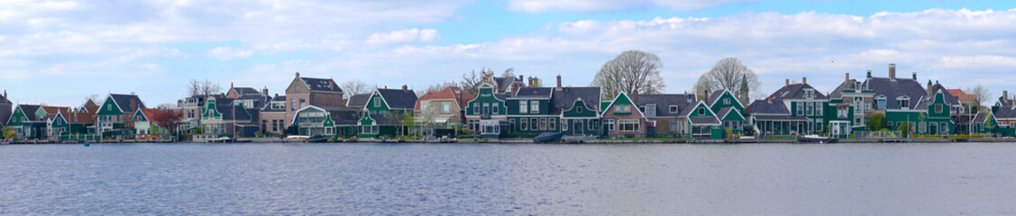 Fototapeta na wymiar Zaandam, The Netherlands, April 11, 2019: Houses located on the Oude Haven in Zaandam