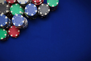 Poker chips on blue background
