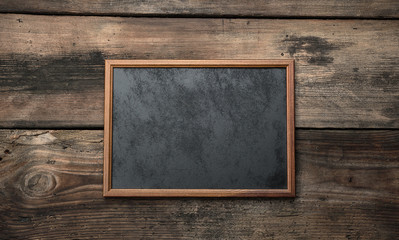 wooden empty chalk board on a brown wooden background