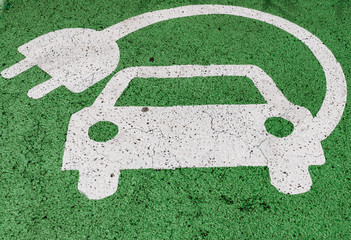 Green electric car parking sign, painted on asphalt