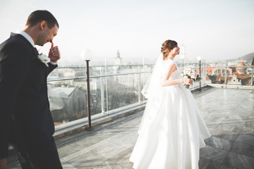 Gorgeous wedding couple walking in the old city of Lviv