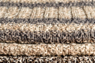 Knitted things stacked. Miscellaneous knitting. Cozy wardrobe.