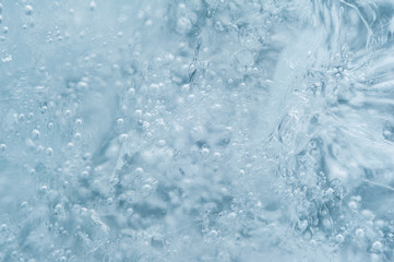 Ice with bubbles background texture. Refreshing summer drinks or arctic cold concept.