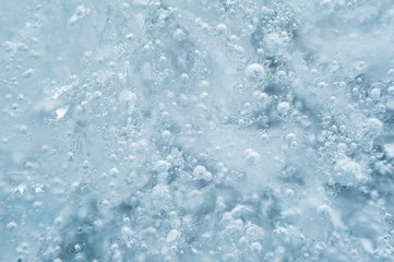 Ice with bubbles background texture. Refreshing summer drinks or arctic cold concept.