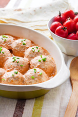 Chacken meatballs baked in creamy tomato sauce