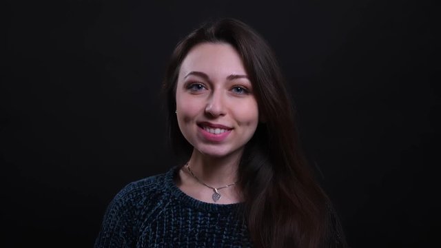Closeup portrait of adult beautiful caucasian brunette female smiling happily looking at camera with background isolated on black