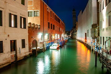 Obraz na płótnie Canvas Night panorama view to Venice canals. Typical Venice street with canal, boat and famous architecture. Historical centre, canals at night.